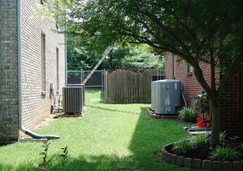 Multiple outdoor AC units installed in a residential backyard by MMI Climate Solutions in Lexington, KY.