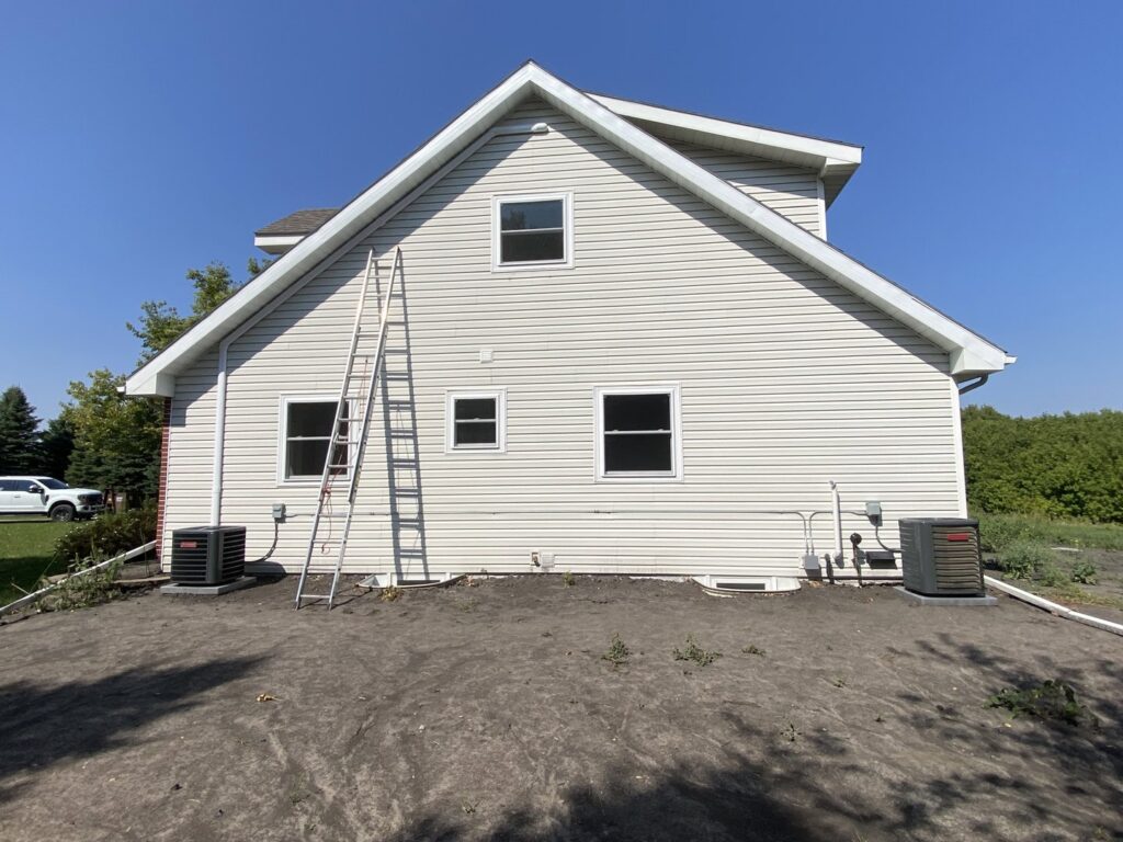 Multiple outdoor air conditioning units installed on the side of a residential property by True Comfort Heating and Cooling in Sherwood, AR.