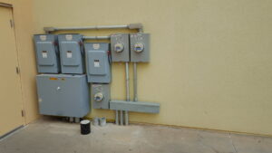 Multiple outdoor electrical meters and panels installed on a building by Red Earth Electric LLC in Oklahoma City, OK.