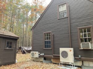 Two outdoor heat pump units professionally installed side-by-side next to a house, demonstrating HVAC work by A&D Ductless LLC in Lunenburg, MA.