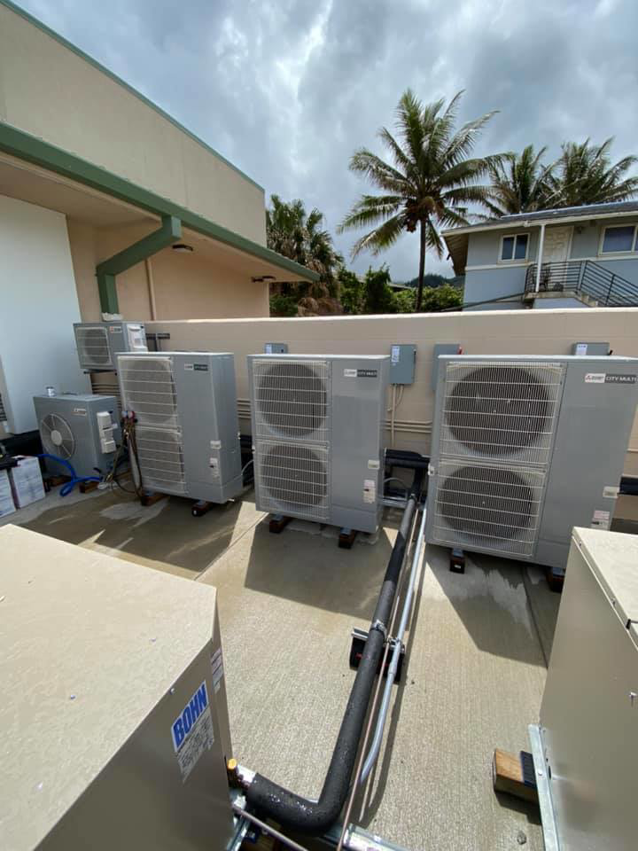 Multiple outdoor HVAC condenser units installed on a rooftop by Air Source, LLC in Honolulu, HI.