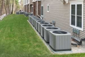 Multiple outdoor HVAC condenser units lined up next to a building, serviced by Moss Creek HVAC Services in Colorado Springs, CO