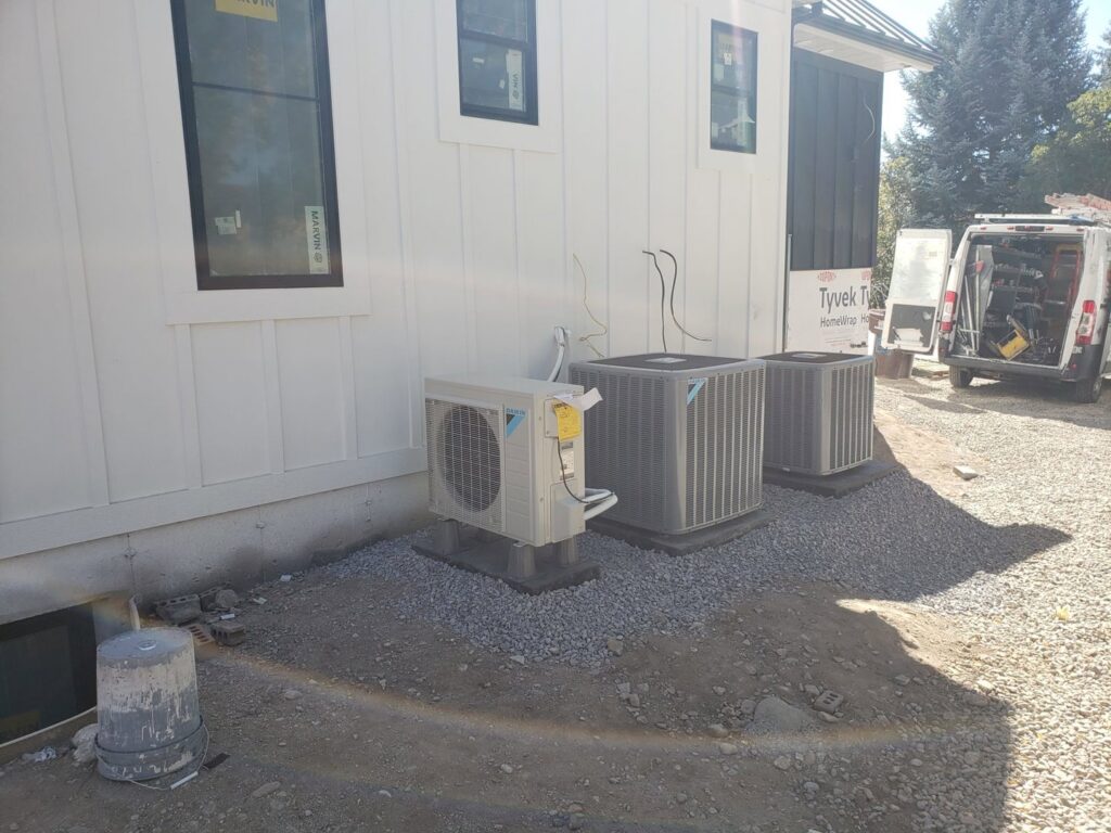 Multiple outdoor HVAC units installed at a new construction site by ABT Heating and Cooling in Orem, UT.