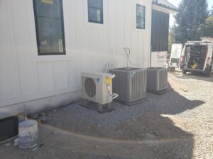 Multiple outdoor HVAC units installed at a new construction site by ABT Heating and Cooling in Orem, UT.