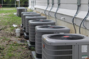 Multiple outdoor HVAC units installed along the side of a building by Comfort Shield HVAC Services of NC in Smithfield, NC.