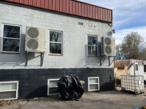 Multiple outdoor mini-split condenser units installed on the side of a building by Stanton Home Comfort in Fordland, MO.