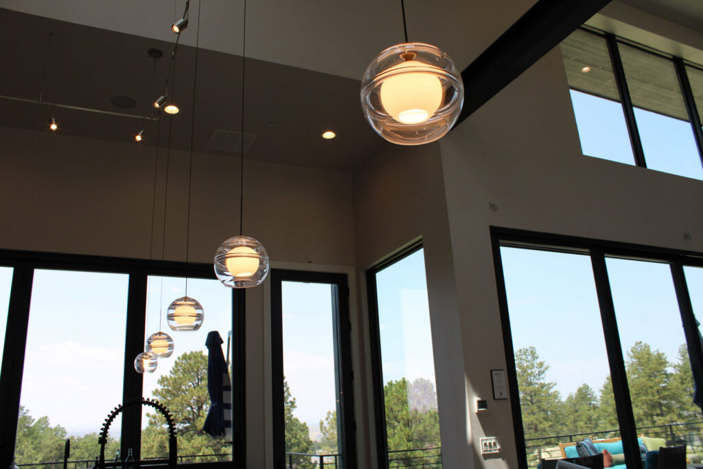 Interior space featuring multiple modern pendant lights and recessed lighting installed by ACJ Electric LLC in North Babylon, NY.
