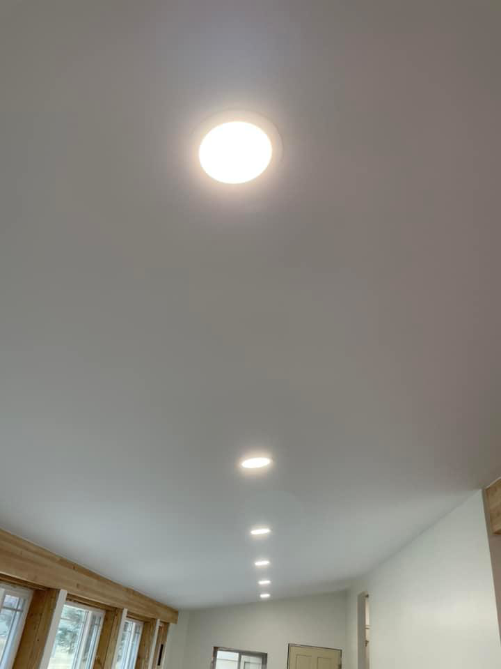 A row of bright recessed lights installed on a ceiling by C&J Electric in Miles City, MT.