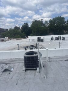 Multiple outdoor AC condenser units installed on a commercial rooftop by Best Plumbing Heating & Cooling Contractors in Albany, NY.