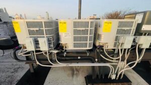 Multiple outdoor HVAC condenser units installed on a commercial rooftop by Deboque Duct Design Corp. in Staten Island, NY