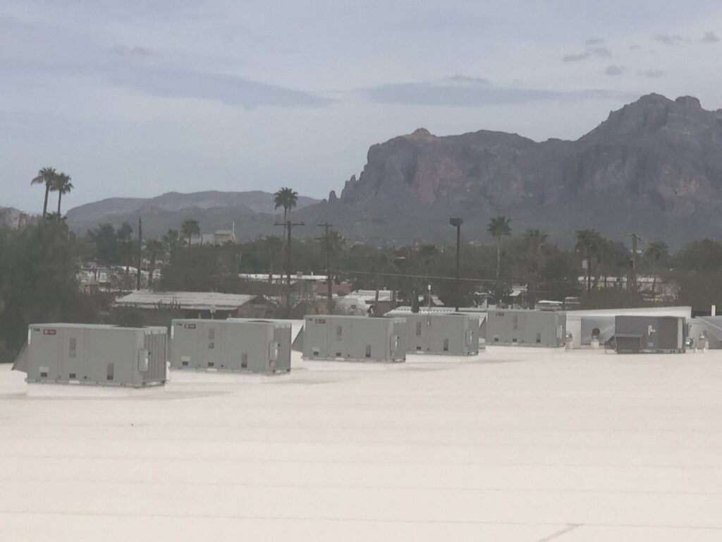 Multiple rooftop HVAC units on a commercial building, maintained by All Metro Air Conditioning in Apache Junction, AZ.
