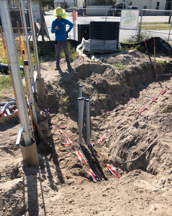 Multiple underground electrical conduits emerging from a trench, installed by Canseco Electrical Contractors, Inc. in Miami, FL.
