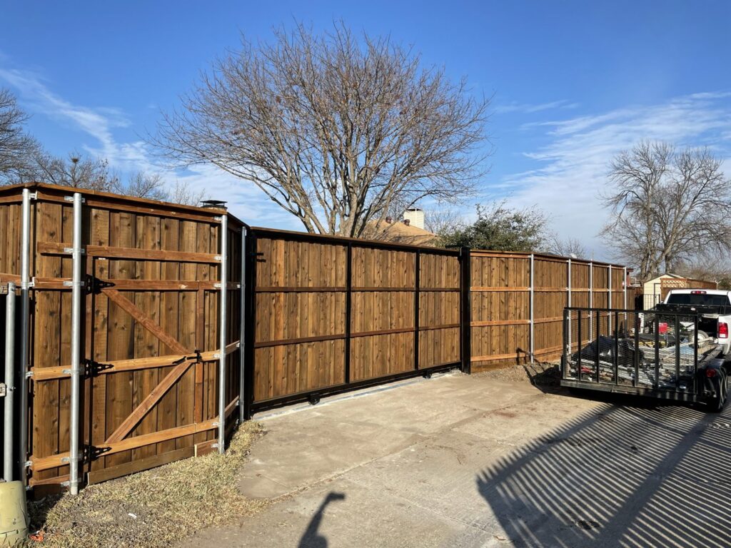 Multiple wood sliding gates and a long fence line installed by Franco Fence in Garland, TX.