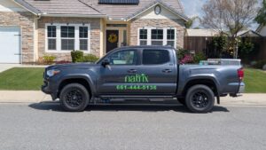 A Natrix Pest Control service truck parked in front of a residential home in Bakersfield, CA, ready for a pest control job.