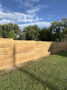 A newly installed natural wood horizontal slat fence in a residential yard by All Over Fence Idaho in Jerome, ID