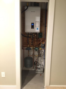 A Navien tankless water heater system expertly installed inside a utility closet by MTL Heating and Cooling LLC in West Haven, CT