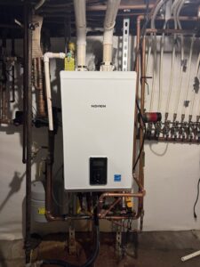 A newly installed Navien tankless water heater with copper piping by Advantage Plumbing Heating & Air in Vandalia, OH.