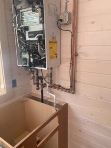 A Navien tankless water heater installation with copper piping by Excel Mechanical and Construction LLC in Brunswick, ME