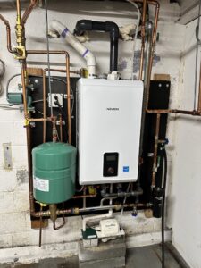 A Navien tankless water heater and associated plumbing installed by Mueller Mechanical HVAC in Philadelphia, PA.