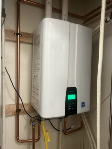 A newly installed Navien tankless water heater with visible piping by Service Experts Denver in Westminster, CO