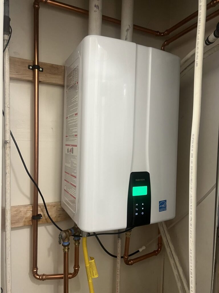 A newly installed Navien tankless water heater with visible piping by Service Experts Denver in Westminster, CO