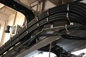 Neatly bundled electrical cables installed on cable trays, showcasing professional wiring by Elmore Electric in Dover, IL.