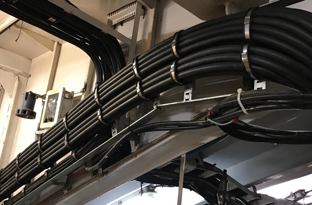 Neatly bundled electrical cables installed on cable trays, showcasing professional wiring by Elmore Electric in Dover, IL.