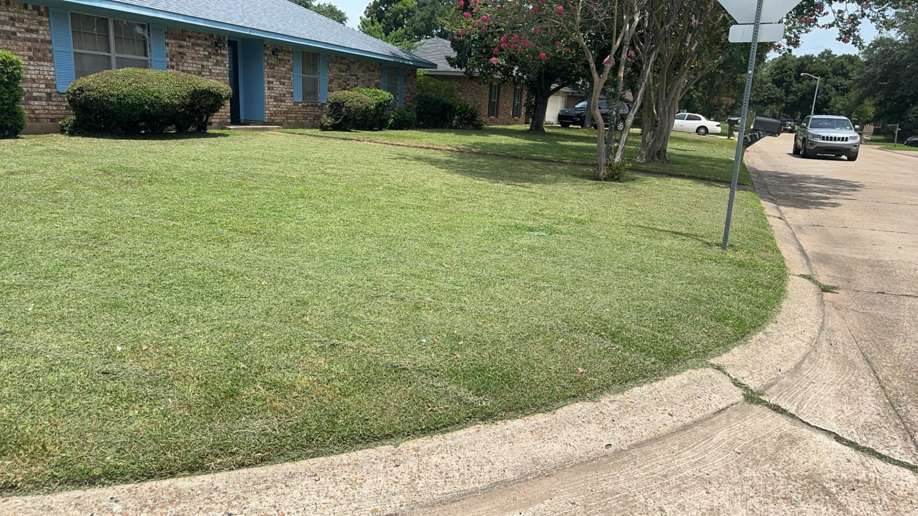 A neatly edged front yard with a healthy green lawn by Minors lawn care service in Canton, OH.