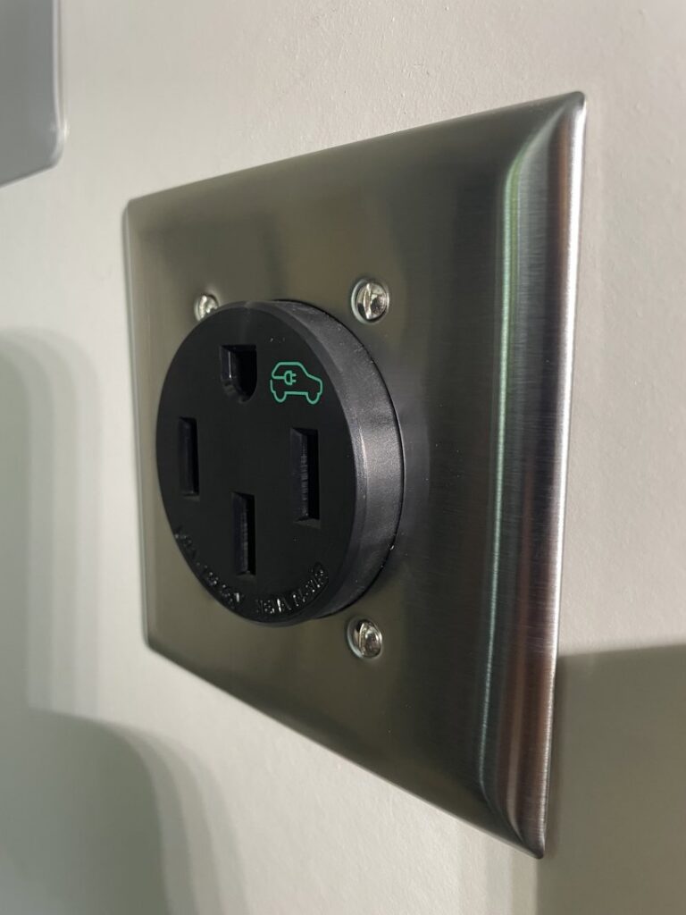 A NEMA 14-50 outlet with a brushed metal faceplate installed by Delatour Electric in Portland, OR.
