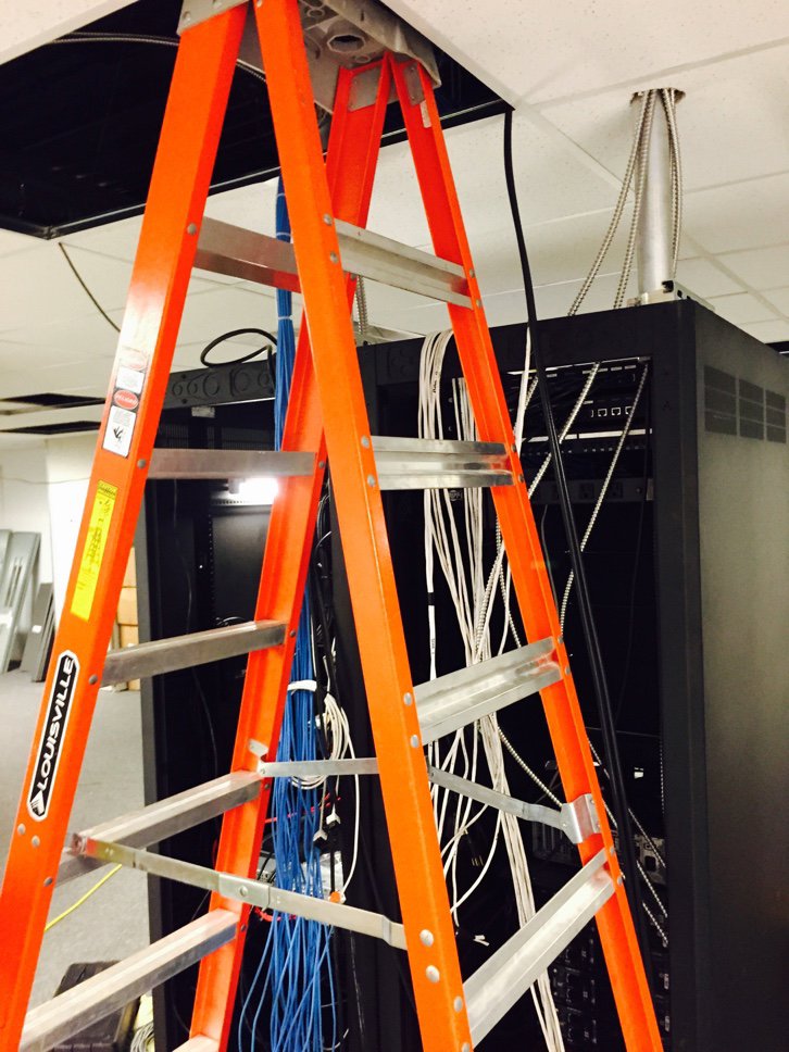 Orange ladder positioned for network cabling installation with blue and white cables at D & D Cabling Solutions in Arlington, TX.