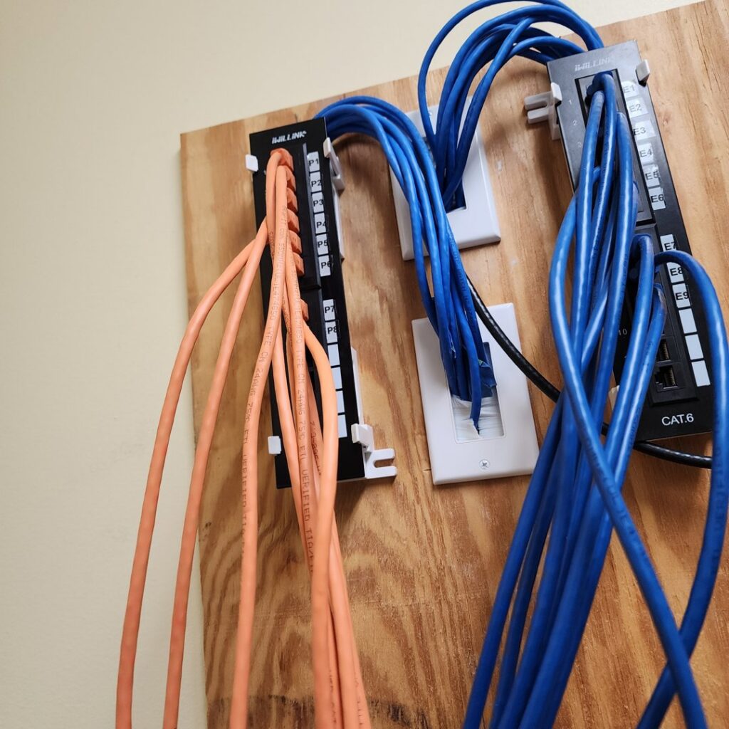 Close-up of network patch panels and organized cabling installation by True Vine Electric in Raleigh, NC
