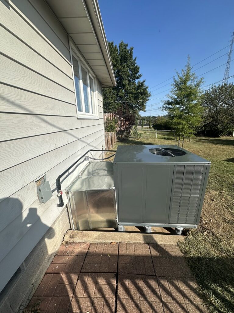 A new outdoor AC unit and connected ductwork installed by One Hour Heating & Air Conditioning of Springfield in Springfield, MO.