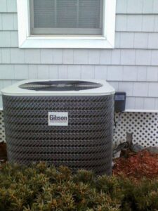 A newly installed Gibson outdoor AC unit next to a residential building by Allwaysthere Heating and Cooling in Frederick, MD