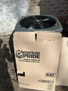 A new American Pride outdoor AC unit being installed by Guy's Heating And Cooling in Kansas City, MO.