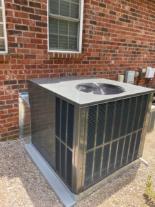 A newly installed outdoor AC unit next to a brick house by MTZ Heating and Air Conditioning in Charlotte, NC.