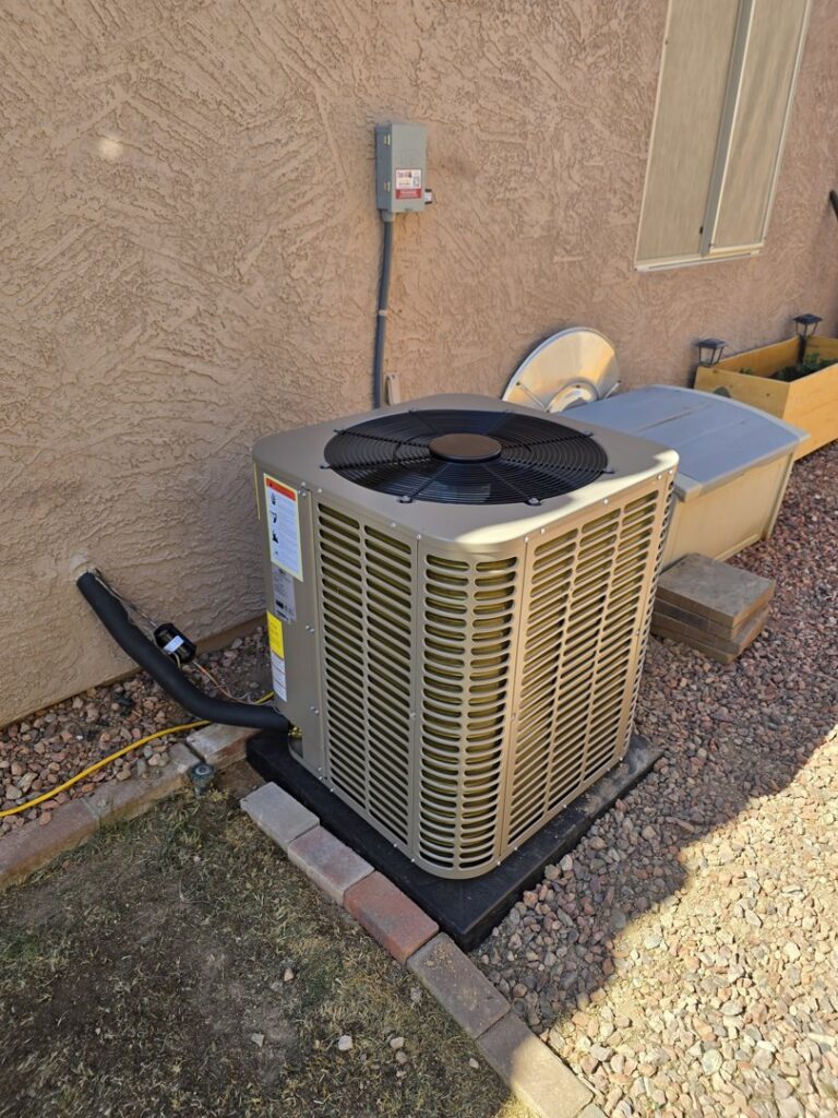 A newly installed outdoor AC unit next to a stucco house, showcasing HVAC installation by State 48 Home Comfort LLC in Peoria, AZ.