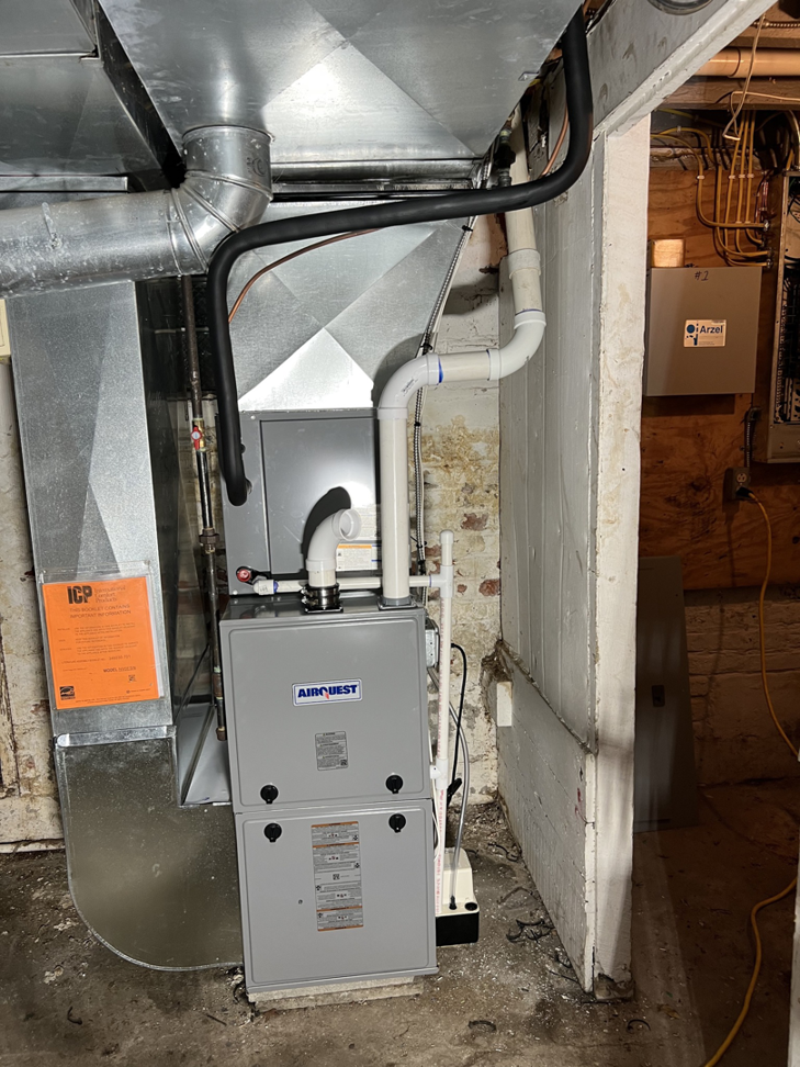 A newly installed Airquest furnace and ductwork in a basement by Daab Heating & Cooling LLC in Parma, OH.