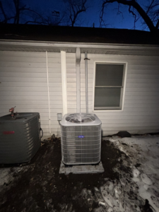 A new and an older outdoor AC condenser unit next to a home, installed by AAA Heating & Air Conditioning Service Inc. in Lexington, KY.