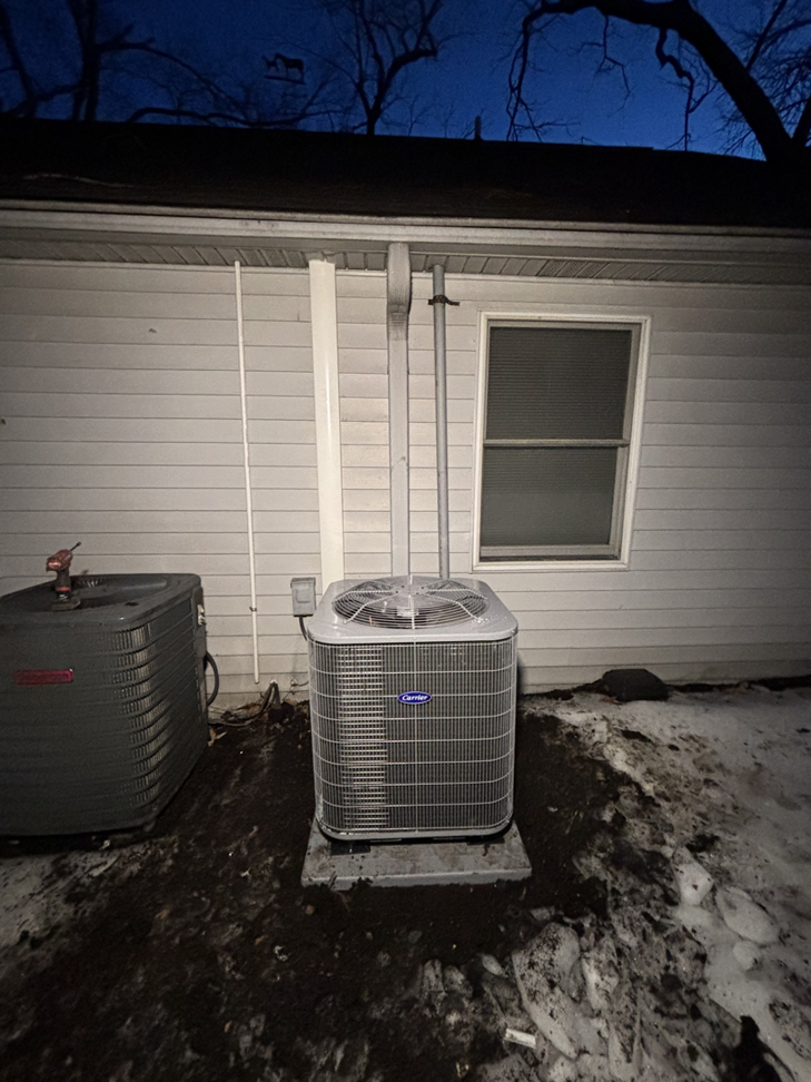 A new and an older outdoor AC condenser unit next to a home, installed by AAA Heating & Air Conditioning Service Inc. in Lexington, KY.