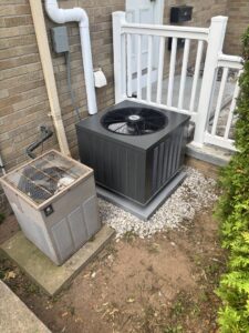 New and old outdoor AC units, showcasing replacement services by Frank N Frank Mechanical Contractors in Rochester, NY.
