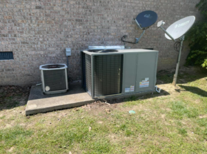 A new and an older outdoor HVAC unit installed next to a brick house by Wright Air Care in Murfreesboro, TN.