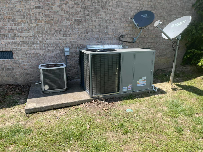 A new and an older outdoor HVAC unit installed next to a brick house by Wright Air Care in Murfreesboro, TN.