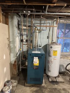 A newly installed boiler and water heater system in a basement by Alpine Pro Solutions in Allentown, PA.