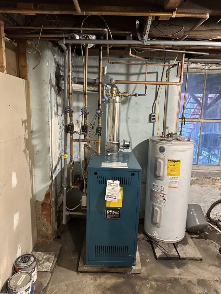 A newly installed boiler and water heater system in a basement by Alpine Pro Solutions in Allentown, PA.