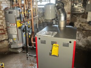A new boiler and hot water tank installation with copper piping by Evergreen Services in Warwick, RI.