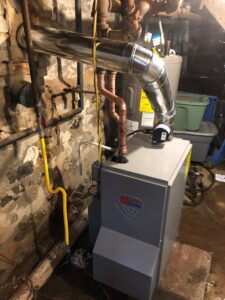 A new U Heating boiler installation with updated piping and venting in a basement by Green Air Heating&Cooling in Philadelphia, PA.