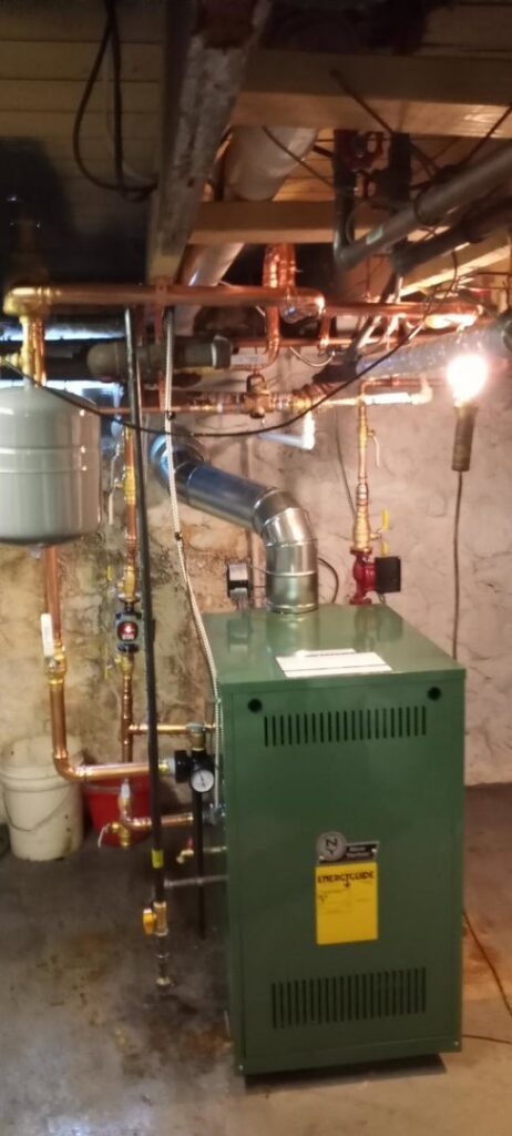 A newly installed boiler heating system with copper piping in a basement by Air Doctors Heating and Air Conditioning in Kenosha, WI.
