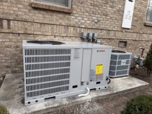 Two new Bosch outdoor HVAC units, a large and a smaller one, installed by Mission HVAC in Huntsville, AL.
