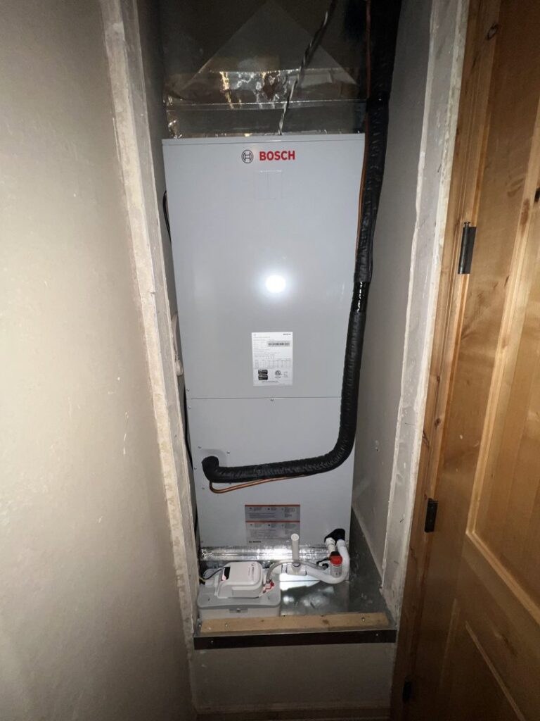 A new Bosch indoor HVAC air handler installed in a utility closet by Arrow Pro Services in Gilbert, AZ