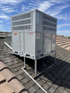A new Bosch rooftop HVAC unit installed on a building by Arrow Pro Services in Gilbert, AZ